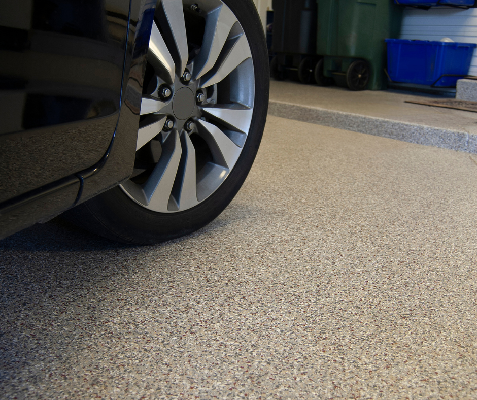 Car parked on epoxy and rubber flake-coated garage floor