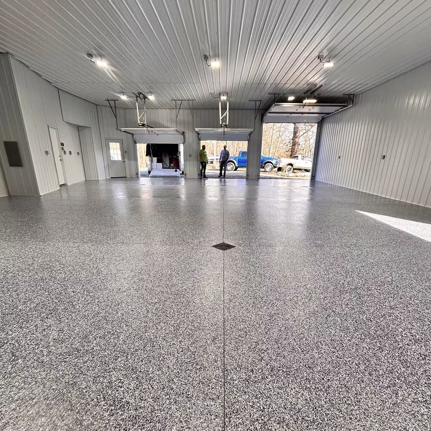 Finished garage floor with a decorative concrete coating wrapper.