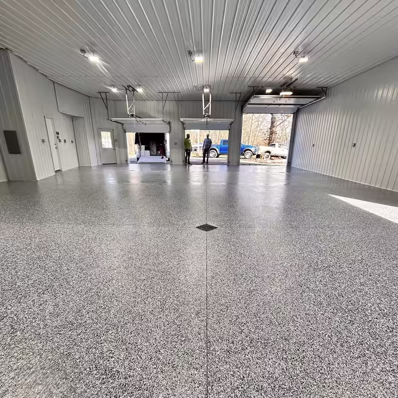 Coated concrete garage floor with a protective polyurea finish.