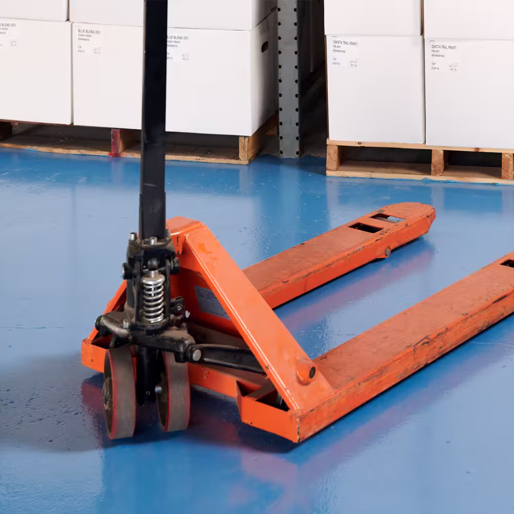 Solid color polyurea concrete floor coating in a commercial parts storage warehouse.